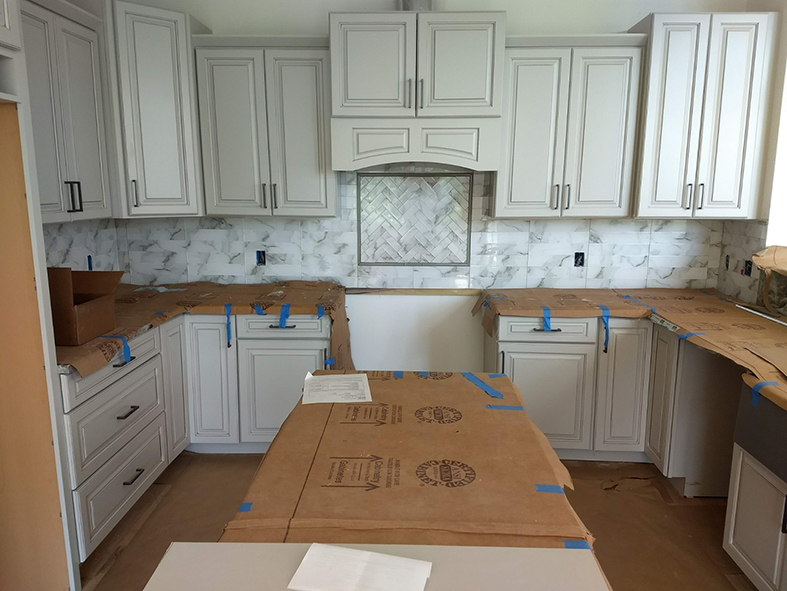 Brooklyn cabinets with custom herringbone backsplash in Asheville kitchen remodel