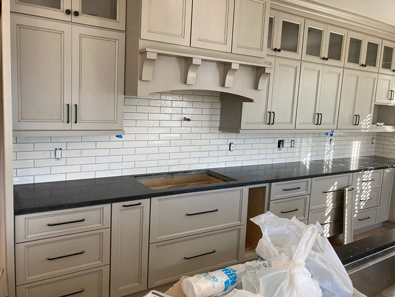 Custom Kitchen Remodeling Asheville - Picture frame cabinets with black quartz countertop and subway tile