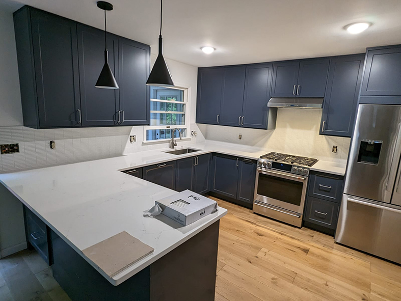 Navy blue Shaker cabinets with white quartz countertop in Asheville kitchen remodel