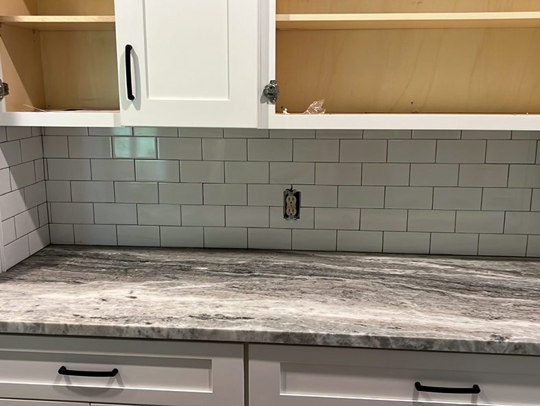 Custom Kitchen Remodeling - White Shaker cabinets with subway tile and marble leather finish countertop