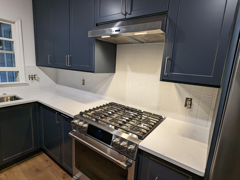 Navy blue Shaker cabinets with white quartz countertop in Asheville kitchen remodel