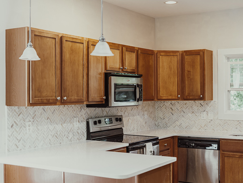 Herringbone backsplash with slim Shaker cabinets in Asheville kitchen remodel