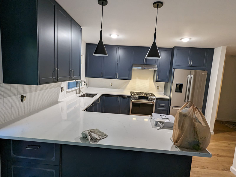 Navy blue Shaker cabinets with white quartz countertop in Asheville kitchen remodel