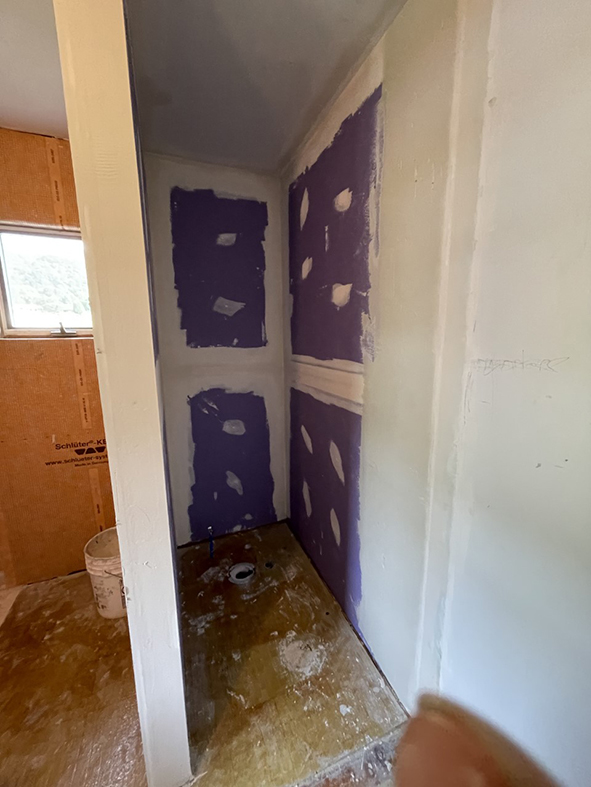 Purple drywall for shower installation