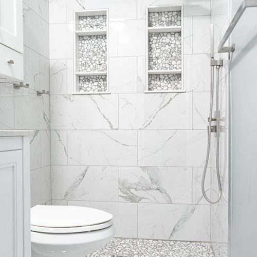 Custom bathroom remodeling Asheville - bathroom with two custom niches wrapped in marble